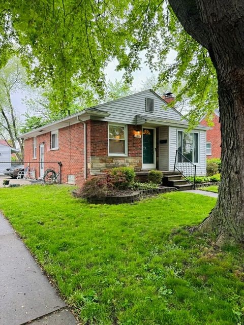 11427 Mercedes, Redford, MI 48239 - view of front facade with a chimney, a front yard, and brick siding