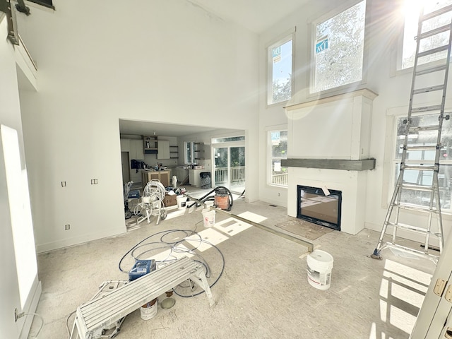 1969 Northfield Ct SW, Byron Center, MI 49315 - living room featuring a high ceiling, plenty of natural light, and a fireplace