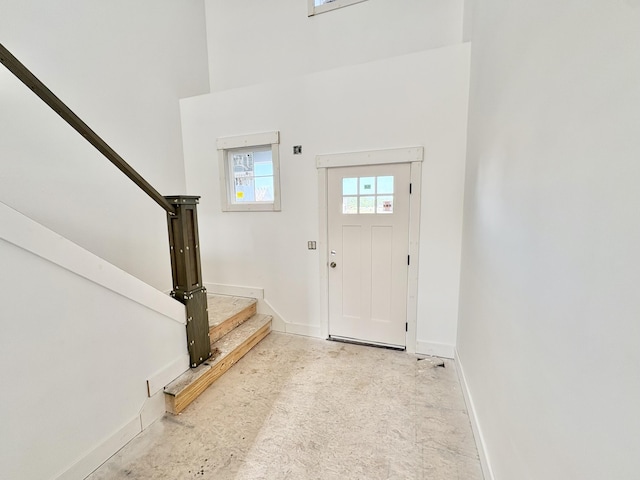 1969 Northfield Ct SW, Byron Center, MI 49315 - entrance foyer with stairway, a towering ceiling, and concrete floors
