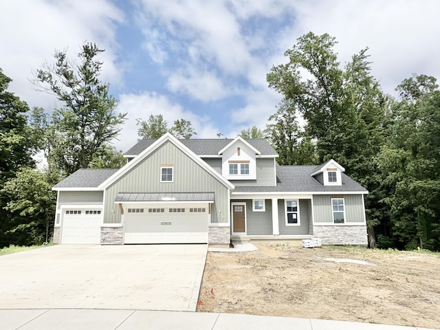 1969 Northfield Ct SW, Byron Center, MI 49315 - craftsman-style house featuring stone siding, driveway, board and batten siding, a shingled roof, and a garage