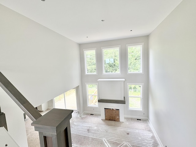 1969 Northfield Ct SW, Byron Center, MI 49315 - unfurnished living room featuring plenty of natural light and a high ceiling