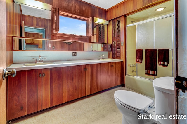 bathroom with toilet, shower / bath combination with glass door, and double vanity