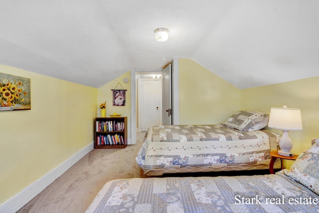 bedroom featuring carpet, baseboards, and lofted ceiling