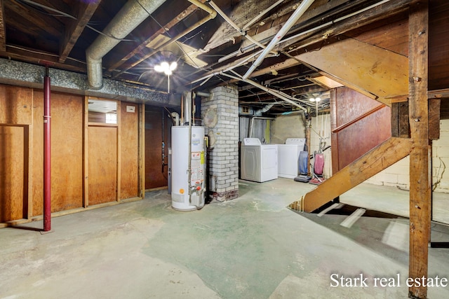 unfinished below grade area featuring gas water heater and separate washer and dryer