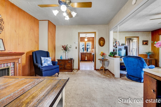 bedroom featuring carpet flooring, a brick fireplace, connected bathroom, ceiling fan, and a textured ceiling