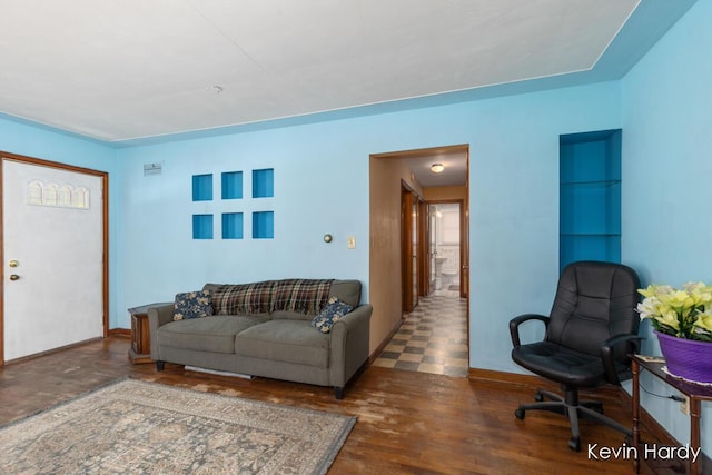 living room with wood finished floors and baseboards