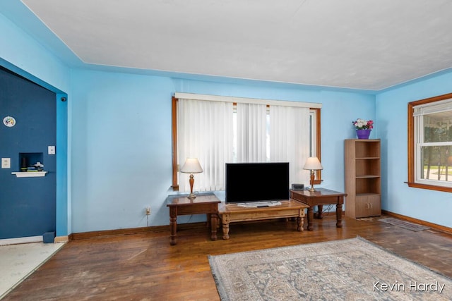 living area with wood finished floors and baseboards