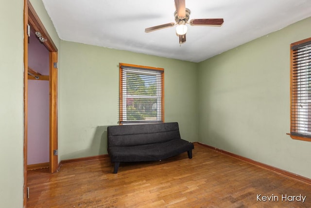 sitting room featuring light wood-style floors, ceiling fan, and baseboards