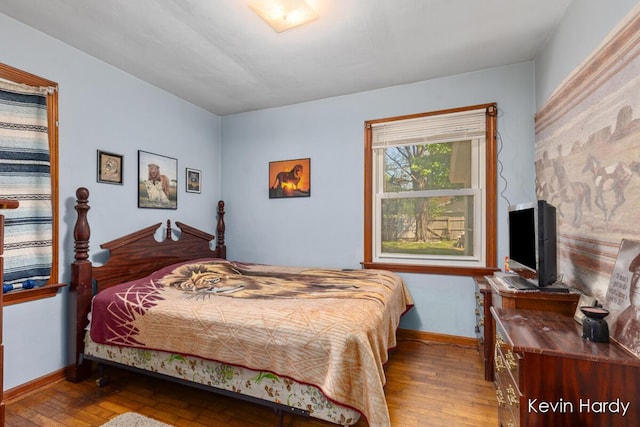 bedroom featuring hardwood / wood-style floors and baseboards