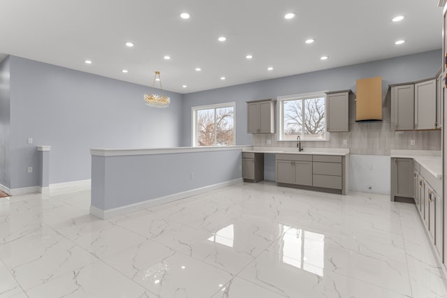 31460 James St, Garden City, MI 48135 - kitchen featuring gray cabinetry, premium range hood, a sink, light marble finish floors, and recessed lighting