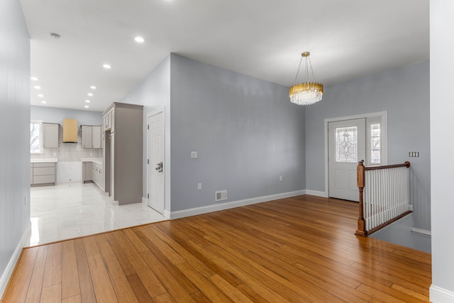 31460 James St, Garden City, MI 48135 - entryway featuring light wood-style floors, a chandelier, recessed lighting, and baseboards