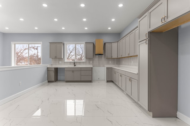 31460 James St, Garden City, MI 48135 - kitchen with gray cabinets, recessed lighting, light marble finish flooring, baseboards, and custom exhaust hood