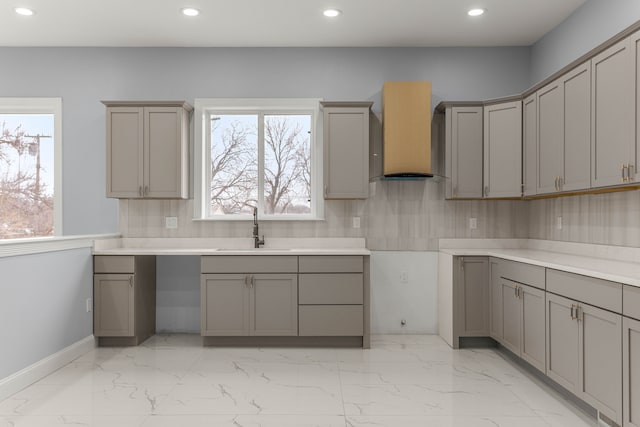 31460 James St, Garden City, MI 48135 - kitchen featuring gray cabinets, a sink, wall chimney exhaust hood, recessed lighting, and light marble finish floors