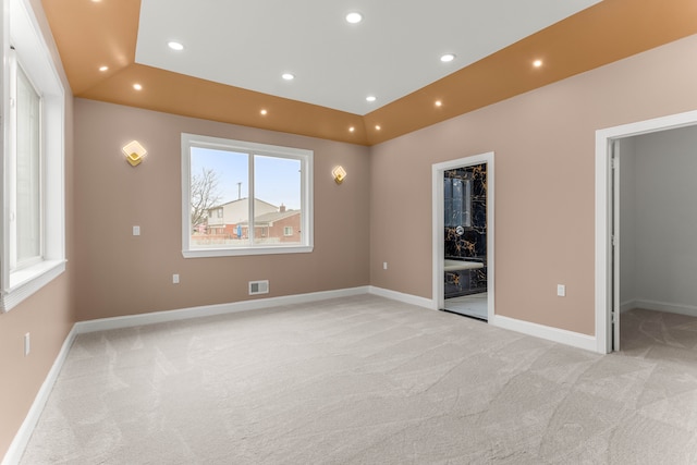31460 James St, Garden City, MI 48135 - unfurnished bedroom featuring a spacious closet, light colored carpet, recessed lighting, baseboards, and a tray ceiling
