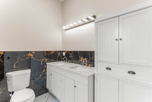 31460 James St, Garden City, MI 48135 - full bathroom featuring toilet, tile walls, marble finish flooring, a wainscoted wall, and double vanity