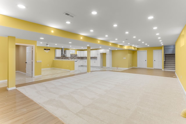 31460 James St, Garden City, MI 48135 - below grade area with baseboards, light wood-type flooring, stairs, and recessed lighting