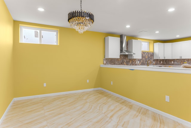 31460 James St, Garden City, MI 48135 - kitchen with wall chimney exhaust hood, white cabinetry, tasteful backsplash, decorative light fixtures, and recessed lighting