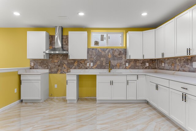 31460 James St, Garden City, MI 48135 - kitchen featuring wall chimney range hood, a sink, tasteful backsplash, white cabinets, and recessed lighting