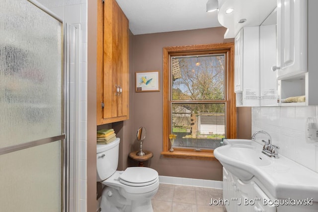1017 Pearl St, Belding, MI 48809 - bathroom featuring tile patterned floors, baseboards, toilet, and a stall shower