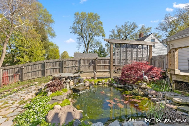 1017 Pearl St, Belding, MI 48809 - fenced backyard with a small pond