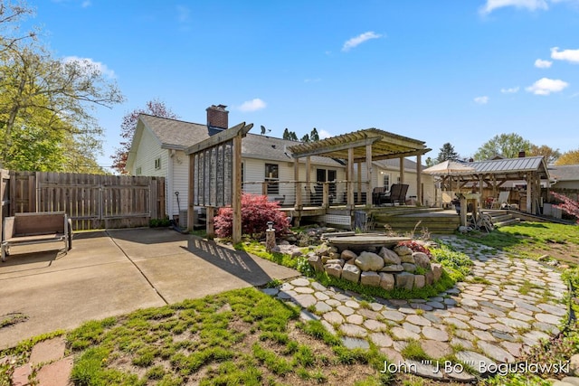 1017 Pearl St, Belding, MI 48809 - back of property featuring a pergola, a wooden deck, fence, and a patio