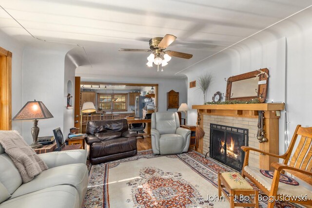 1017 Pearl St, Belding, MI 48809 - living room featuring ceiling fan and a brick fireplace