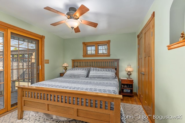 1017 Pearl St, Belding, MI 48809 - bedroom with access to exterior, light wood finished floors, and a ceiling fan