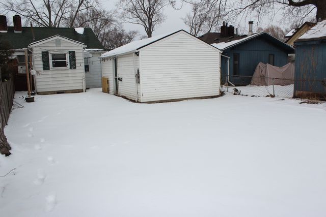 1977 Princeton Rd, Berkley, MI 48072 - yard layered in snow featuring an outdoor structure and fence