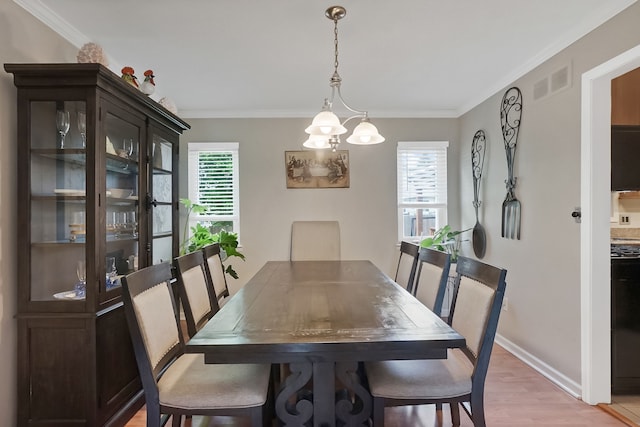 1699 Brentwood Dr, Wixom, MI 48393 - dining space with crown molding, light wood finished floors, baseboards, and a chandelier