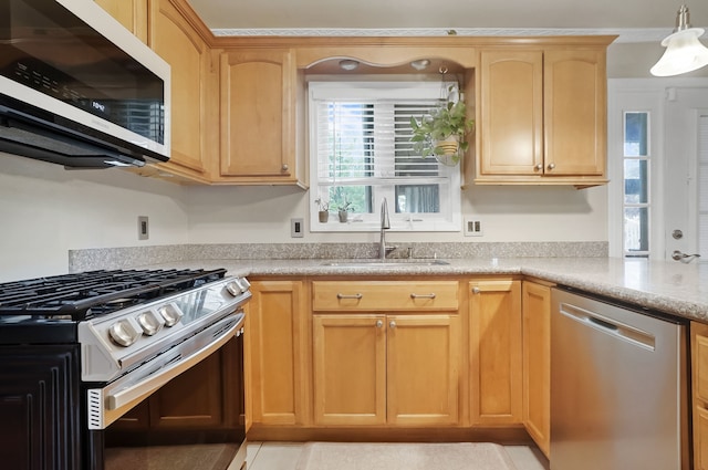 1699 Brentwood Dr, Wixom, MI 48393 - kitchen with appliances with stainless steel finishes, a sink, light countertops, decorative light fixtures, and light brown cabinets