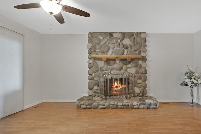 1699 Brentwood Dr, Wixom, MI 48393 - unfurnished living room with wood finished floors, a fireplace, and baseboards