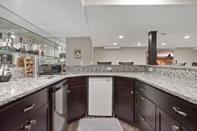1699 Brentwood Dr, Wixom, MI 48393 - kitchen with a sink, light stone countertops, and dark brown cabinets