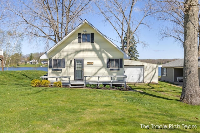7964 W Royal Rd, Stanwood, MI 49346 - rear view of house featuring a water view, a yard, a detached garage, and an outbuilding