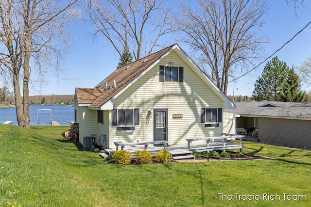 7964 W Royal Rd, Stanwood, MI 49346 - rear view of property with a lawn, a water view, and central AC unit