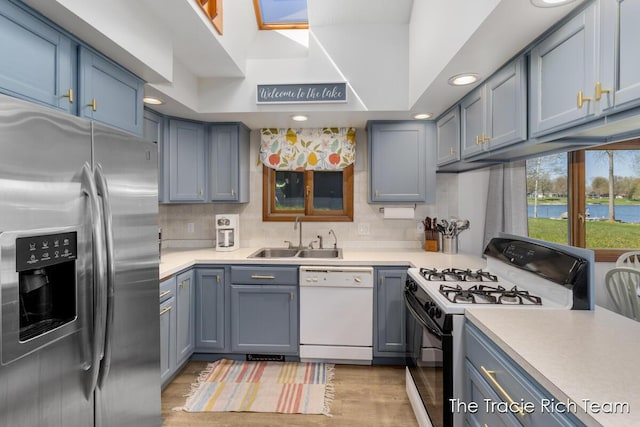 7964 W Royal Rd, Stanwood, MI 49346 - kitchen featuring stainless steel refrigerator with ice dispenser, gas range, a sink, white dishwasher, and light countertops