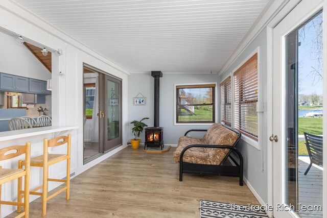 7964 W Royal Rd, Stanwood, MI 49346 - sunroom / solarium with a wood stove, wood finished floors, wood ceiling, lofted ceiling, and baseboards