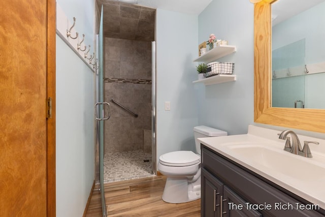 7964 W Royal Rd, Stanwood, MI 49346 - bathroom with wood finished floors, a shower stall, toilet, and vanity