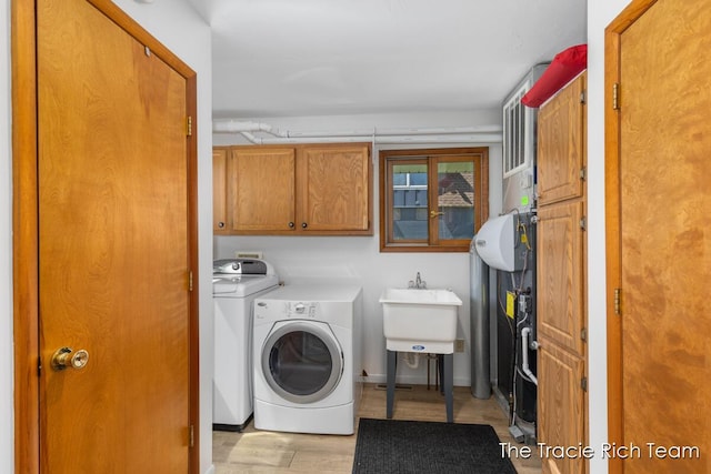 7964 W Royal Rd, Stanwood, MI 49346 - clothes washing area with washer / dryer, cabinet space, and light wood finished floors