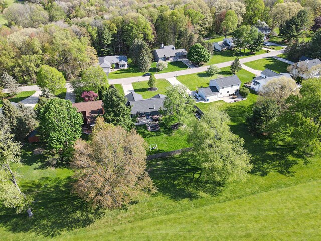 aerial perspective of suburban area featuring a heavily wooded area