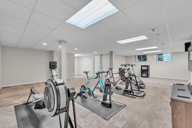 workout area with baseboards, a paneled ceiling, and carpet flooring