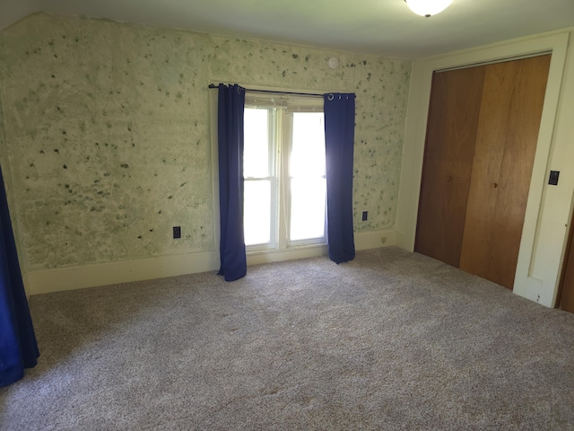 120 S Mackinaw St, Waldron, MI 49288 - unfurnished bedroom with carpet floors, a closet, and wallpapered walls