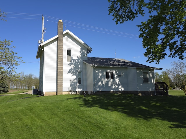 120 S Mackinaw St, Waldron, MI 49288 - view of home's exterior with a lawn, a chimney, and central air condition unit