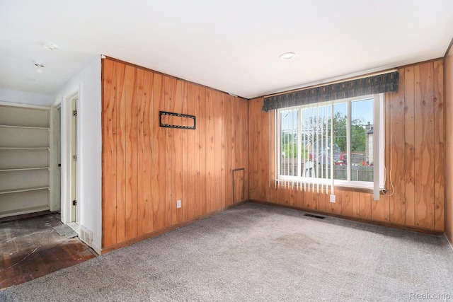 4149 Harriet St, Inkster, MI 48141 - carpeted empty room featuring wood walls, baseboards, and a smoke detector