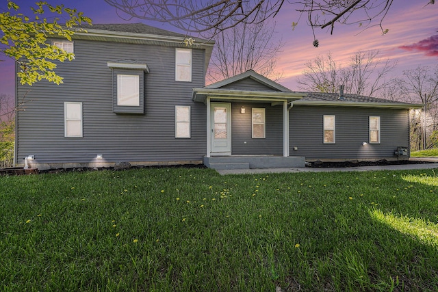 view of front of house with a yard and a porch