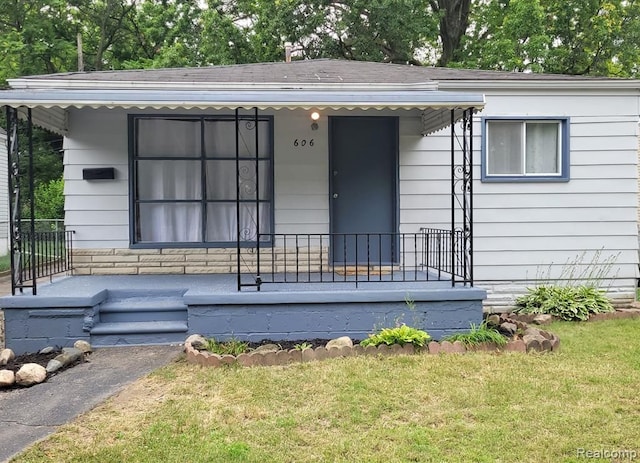 606 E Milton Ave, Hazel Park, MI 48030 - view of front of home with a porch, a front yard, and roof with shingles