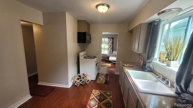 606 E Milton Ave, Hazel Park, MI 48030 - kitchen featuring white gas stove, dark wood-style floors, a sink, baseboards, and light countertops