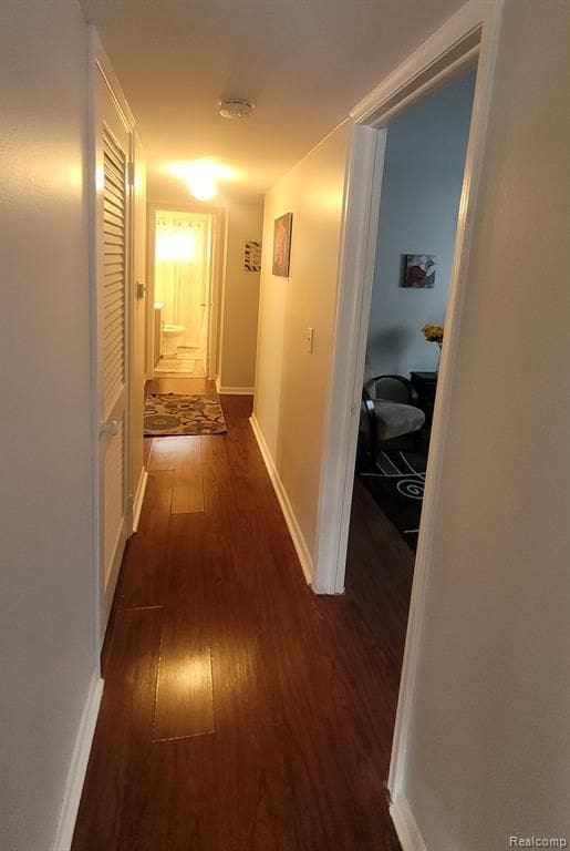 606 E Milton Ave, Hazel Park, MI 48030 - hall with dark wood-style flooring and baseboards