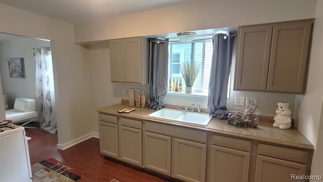 606 E Milton Ave, Hazel Park, MI 48030 - kitchen featuring a sink, dark wood-style flooring, light countertops, range, and baseboards