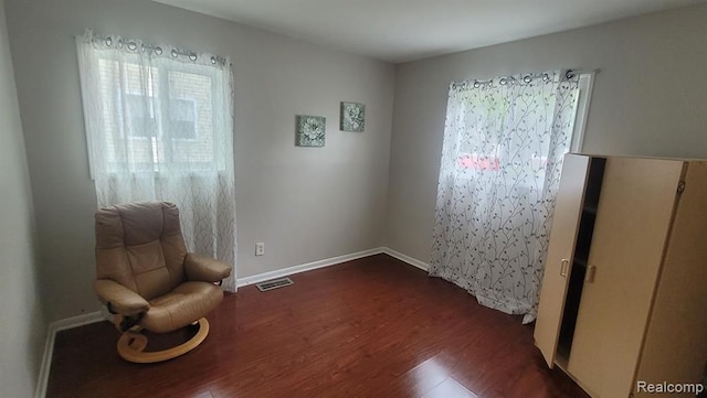 606 E Milton Ave, Hazel Park, MI 48030 - living area with dark wood-style flooring and baseboards