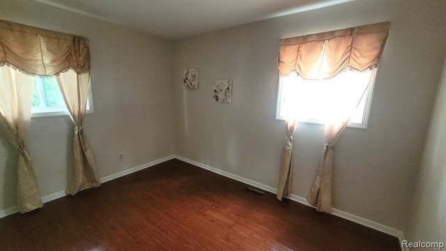 606 E Milton Ave, Hazel Park, MI 48030 - empty room featuring dark wood-style floors and baseboards